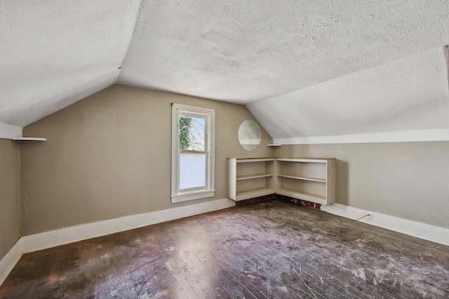 bonus room featuring a textured ceiling, lofted ceiling, and baseboards