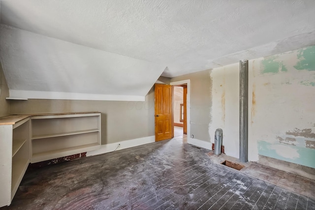 bonus room featuring a textured ceiling and lofted ceiling