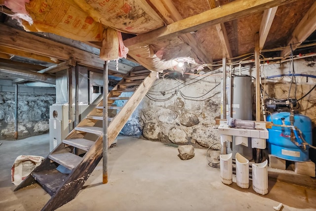 unfinished basement with heating unit and stairway