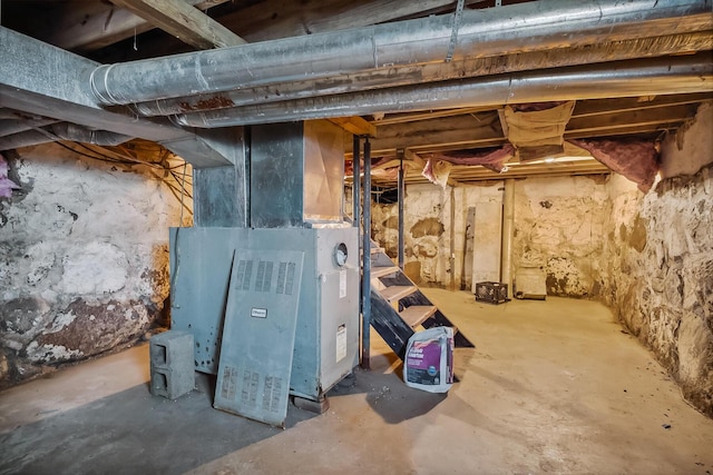 unfinished below grade area featuring heating unit