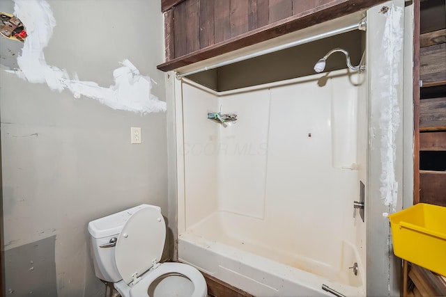 full bathroom with toilet, a tub to relax in, and a shower