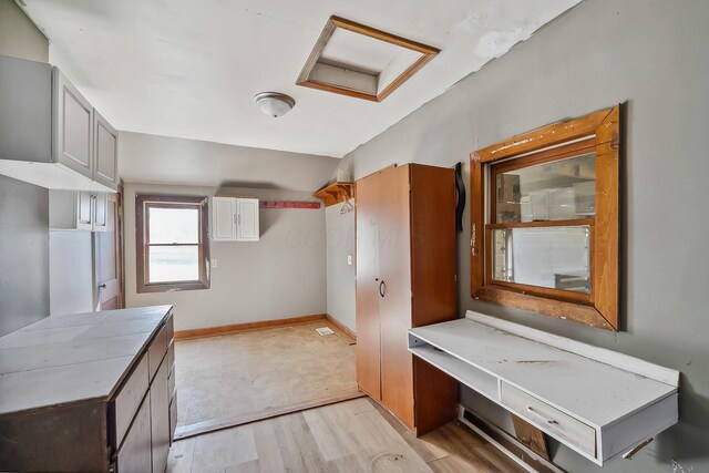 interior space featuring light wood finished floors and baseboards
