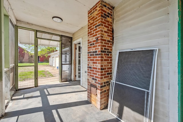 entrance to property featuring brick siding