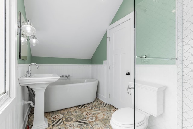 250 E Park St, Westerville, OH 43081 - bathroom with wainscoting, a freestanding bath, and vaulted ceiling