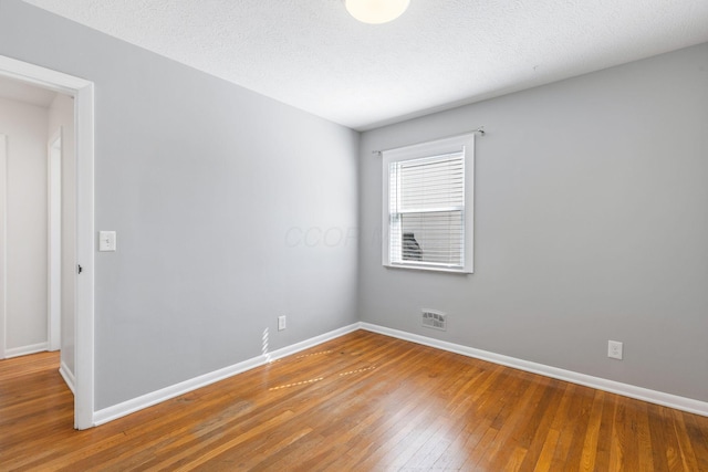 250 E Park St, Westerville, OH 43081 - unfurnished room featuring visible vents, hardwood / wood-style flooring, and baseboards
