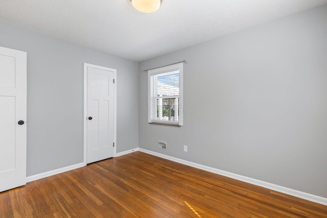 250 E Park St, Westerville, OH 43081 - unfurnished bedroom featuring visible vents, hardwood / wood-style floors, and baseboards