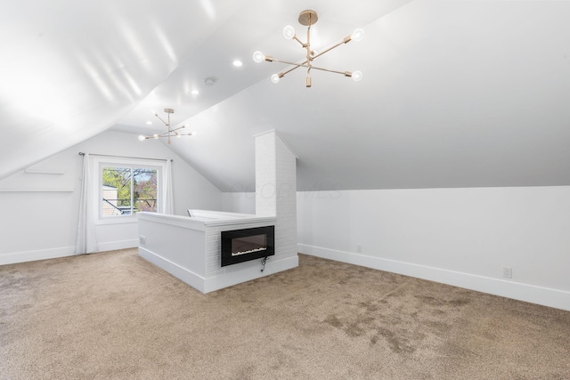 250 E Park St, Westerville, OH 43081 - additional living space featuring vaulted ceiling, carpet flooring, a glass covered fireplace, baseboards, and a notable chandelier