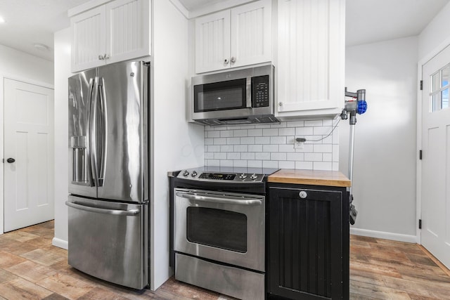 250 E Park St, Westerville, OH 43081 - kitchen with wood counters, baseboards, appliances with stainless steel finishes, and tasteful backsplash