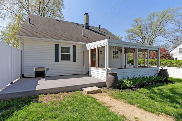250 E Park St, Westerville, OH 43081 - rear view of house with a wooden deck, a chimney, roof with shingles, fence, and a yard