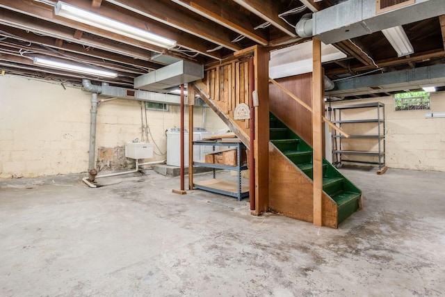 unfinished below grade area featuring washer / dryer, stairs, and visible vents