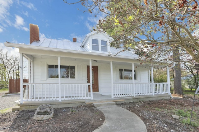 3907 Condit Rd, Sunbury, OH 43074 - view of front of home with metal roof, a standing seam roof, a chimney, and covered porch