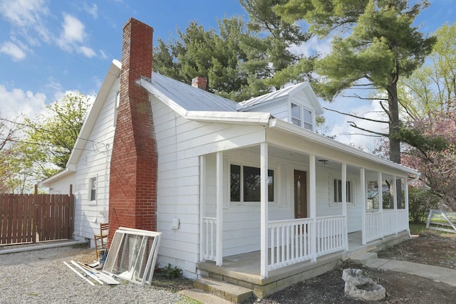 3907 Condit Rd, Sunbury, OH 43074 - view of front of home with fence, a chimney, and covered porch