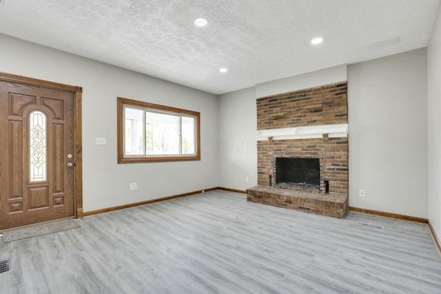 3907 Condit Rd, Sunbury, OH 43074 - unfurnished living room featuring baseboards, wood finished floors, a textured ceiling, and recessed lighting