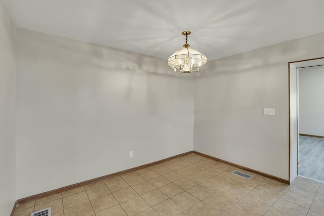 3907 Condit Rd, Sunbury, OH 43074 - unfurnished room featuring light tile patterned floors, visible vents, baseboards, and an inviting chandelier