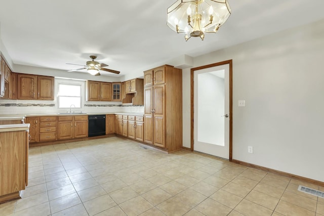 3907 Condit Rd, Sunbury, OH 43074 - kitchen with dishwasher, light countertops, a sink, and brown cabinets