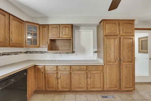 3907 Condit Rd, Sunbury, OH 43074 - kitchen featuring black dishwasher, decorative backsplash, brown cabinets, and light tile patterned floors