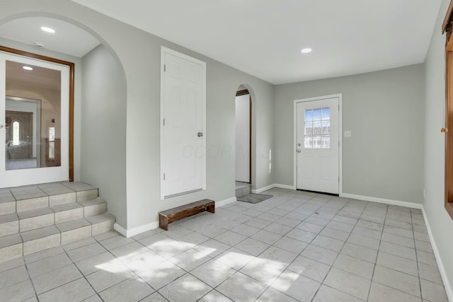 3907 Condit Rd, Sunbury, OH 43074 - entrance foyer featuring arched walkways, baseboards, light tile patterned flooring, and recessed lighting