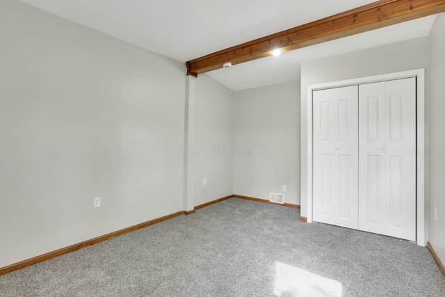3907 Condit Rd, Sunbury, OH 43074 - unfurnished bedroom with a closet, carpet floors, baseboards, beam ceiling, and visible vents
