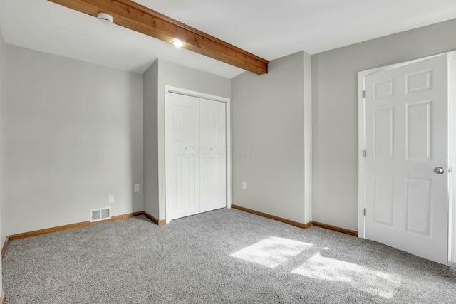3907 Condit Rd, Sunbury, OH 43074 - unfurnished bedroom with a closet, carpet floors, baseboards, beam ceiling, and visible vents