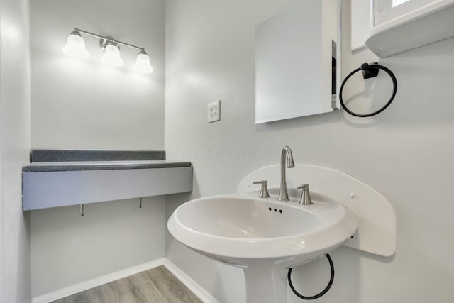 3907 Condit Rd, Sunbury, OH 43074 - bathroom with wood finished floors, baseboards, and a sink