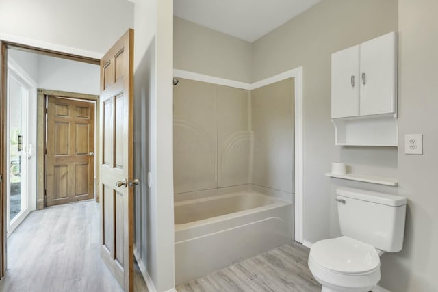 3907 Condit Rd, Sunbury, OH 43074 - full bath featuring wood finished floors, toilet, baseboards, and shower / washtub combination