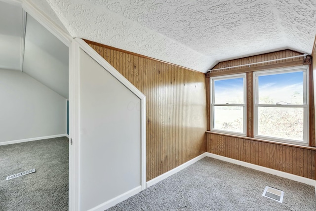 3907 Condit Rd, Sunbury, OH 43074 - bonus room featuring wooden walls, vaulted ceiling, visible vents, and carpet flooring