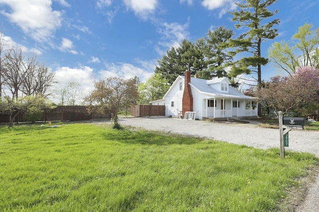 3907 Condit Rd, Sunbury, OH 43074 - view of home's exterior featuring a chimney, fence, a porch, a yard, and metal roof