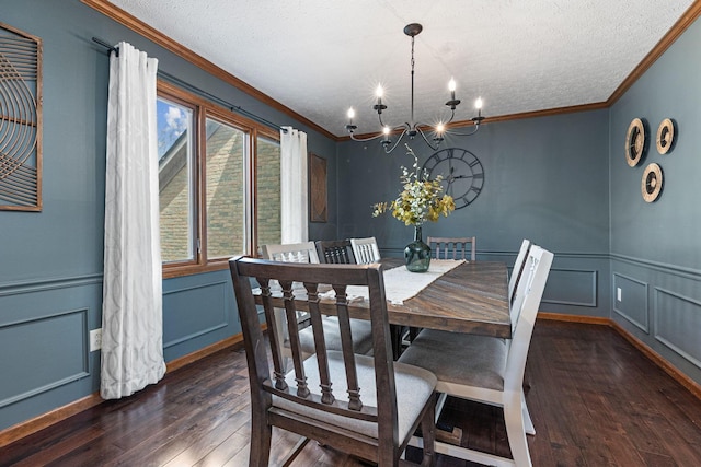 dining area featuring a decorative wall, dark wood-style floors, crown molding, a chandelier, and a textured ceiling