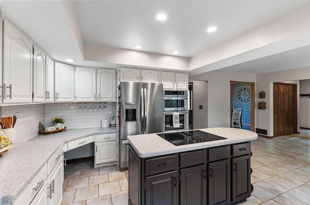 kitchen featuring appliances with stainless steel finishes, white cabinetry, light countertops, and recessed lighting