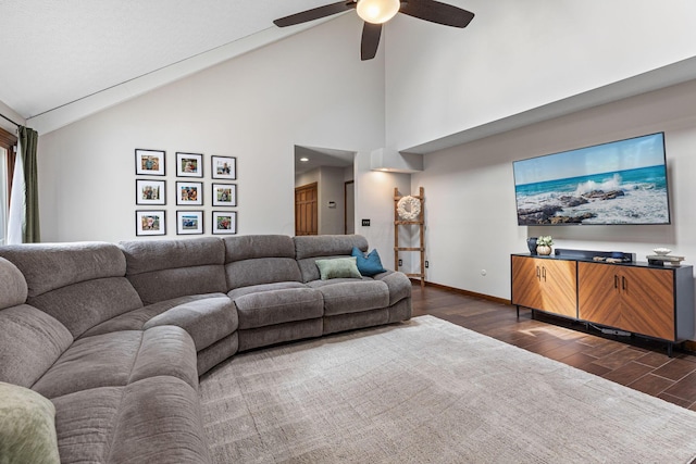 living room with dark wood-style flooring, ceiling fan, baseboards, and high vaulted ceiling