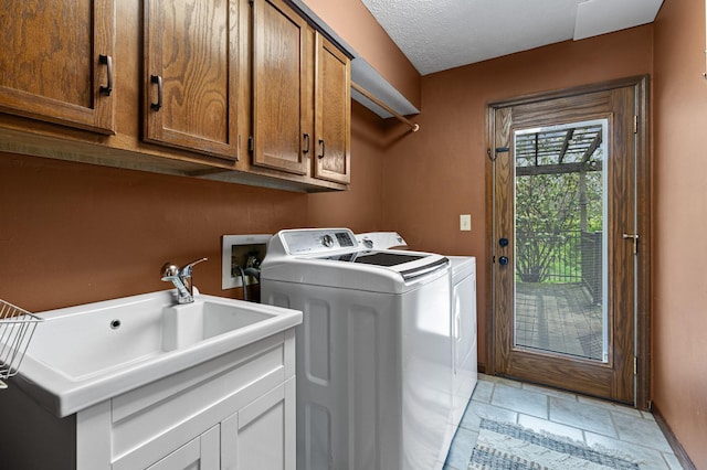 clothes washing area featuring washer and dryer, cabinet space, and baseboards
