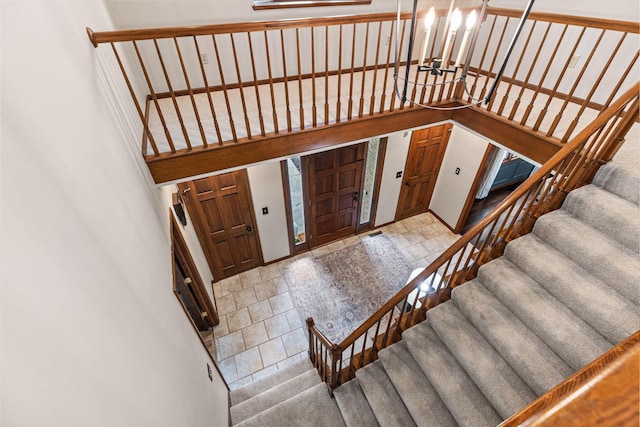 foyer entrance featuring a chandelier and stairway