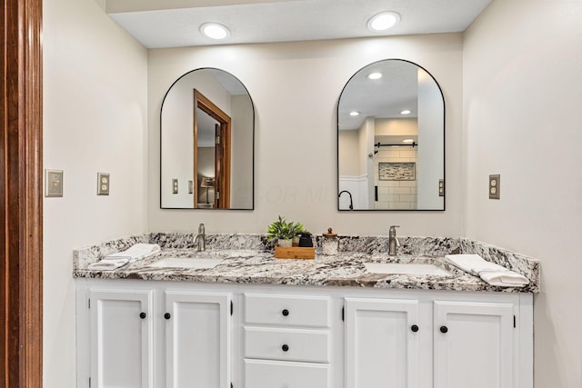 full bathroom with double vanity and recessed lighting
