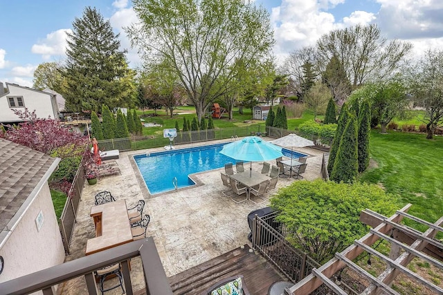 community pool with outdoor dining area and a patio