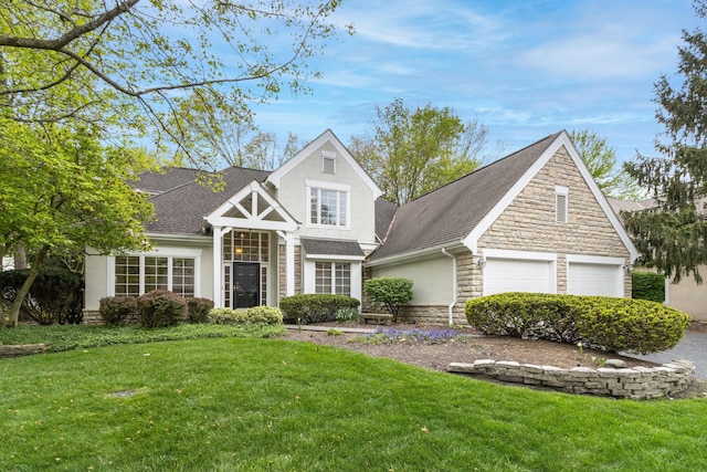 traditional-style home with roof with shingles, a front yard, stone siding, and stucco siding