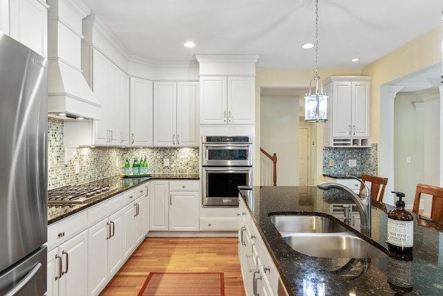 kitchen featuring a sink, appliances with stainless steel finishes, and white cabinets