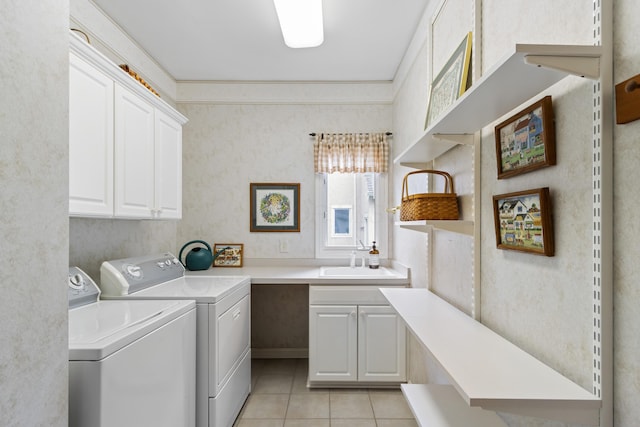 laundry room with cabinet space, a sink, light tile patterned floors, ornamental molding, and washer and clothes dryer