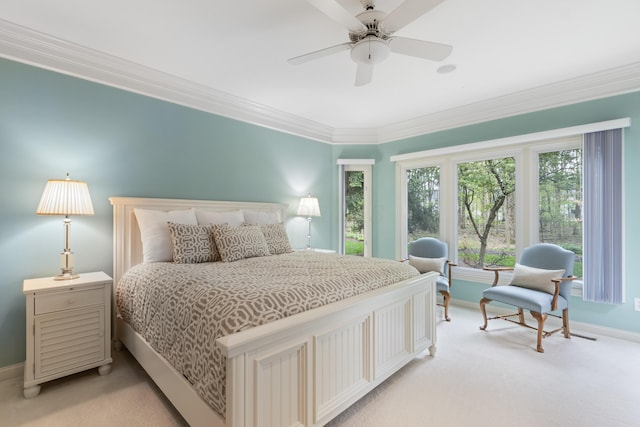 bedroom with crown molding, baseboards, and light carpet