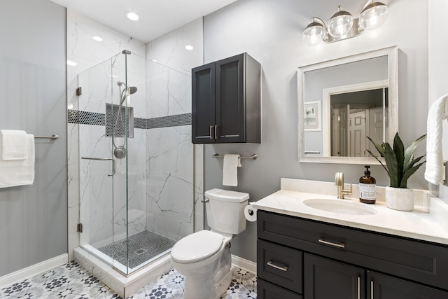 bathroom with baseboards, vanity, toilet, and a marble finish shower