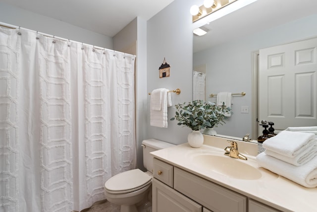 full bath featuring vanity and toilet