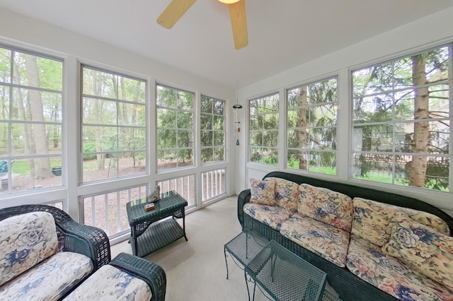 sunroom featuring a healthy amount of sunlight, outdoor lounge area, and a ceiling fan