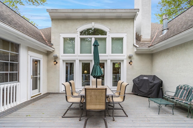 deck featuring outdoor dining area and grilling area