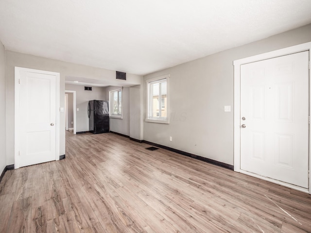 1050-1052 Loretta Ave, Columbus, OH 43211 - unfurnished living room with baseboards, light wood finished floors, and visible vents