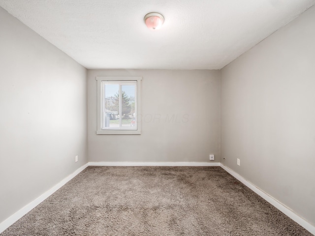 1050-1052 Loretta Ave, Columbus, OH 43211 - carpeted spare room featuring baseboards
