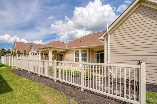 rear view of house with fence