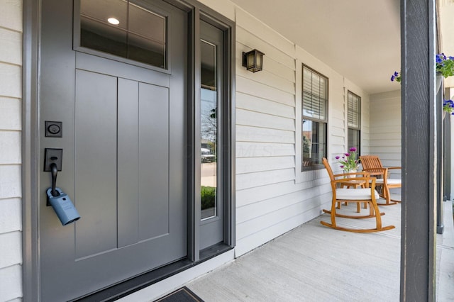 view of exterior entry with a porch