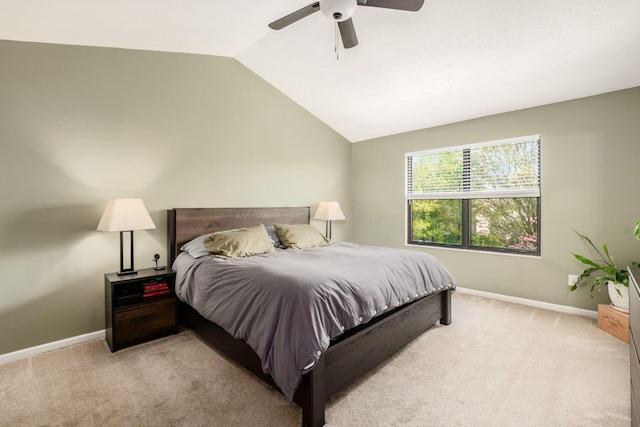carpeted bedroom featuring lofted ceiling, a ceiling fan, and baseboards