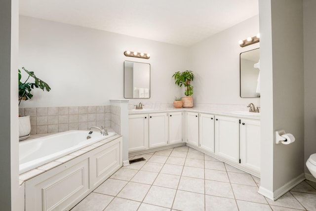 bathroom featuring a bath, tile patterned floors, a sink, and double vanity