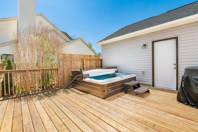 wooden terrace with a covered hot tub