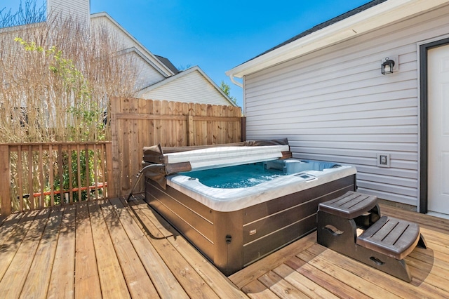wooden terrace with a hot tub